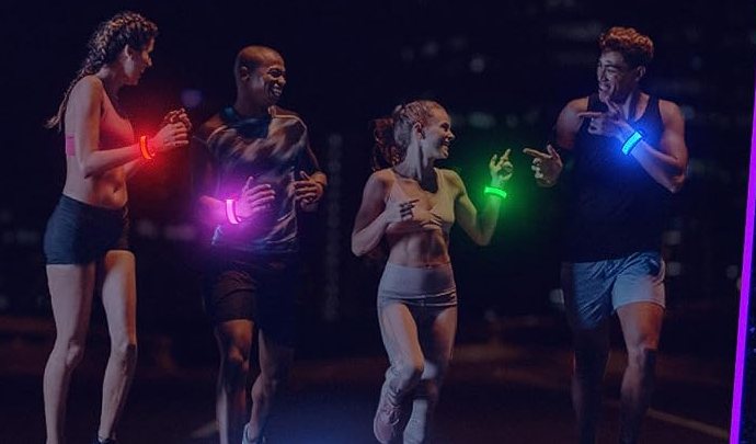 Four runners wearing FANL LED bracelets on a road at night